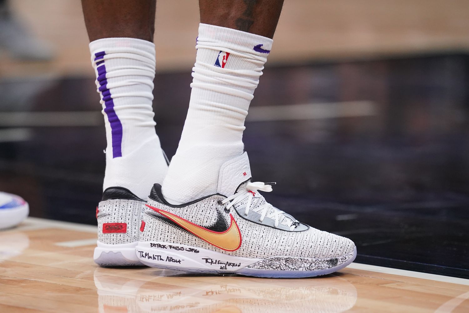 View of grey and gold Nike LeBron shoes.